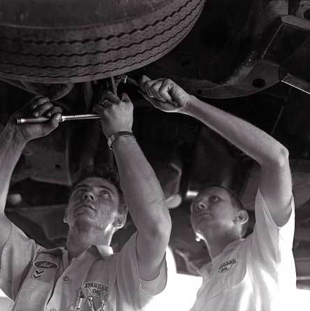 Picture of George Gates and Sid changing a tire